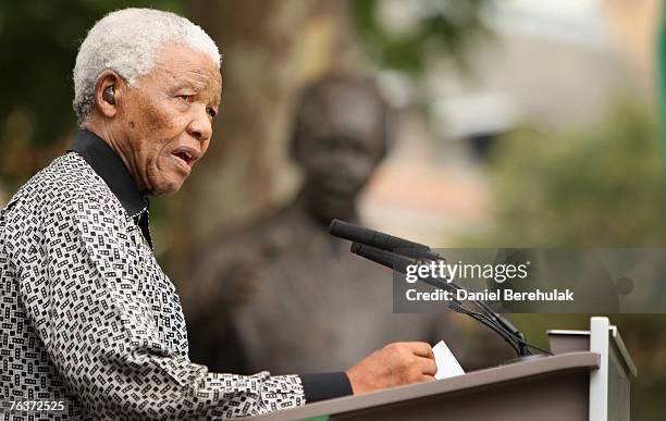 Ex-South African President Nelson Mandela addresses the crowd during a statue unveiling ceremony in his honour at Parliament Square on August 29,...