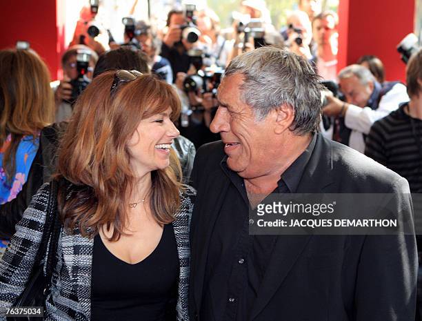 French actress Florence Pernel and actor Jean-Pierre Castaldi pose upon their arrival at The Olympia theater, to attend the presentation of the...
