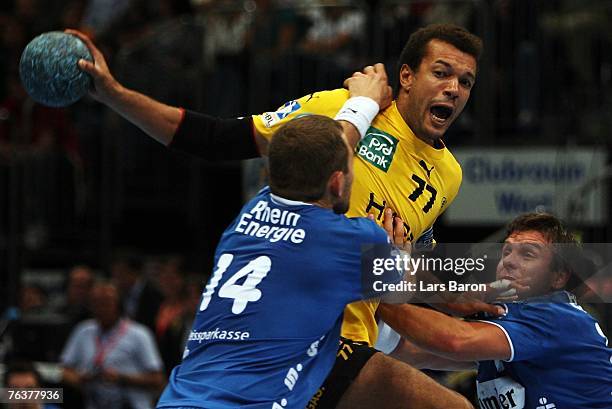 Christian Caillat of Rhein-Neckar in action with Sverre Jakobsson and Robert Gunnarsson of Gummersbach during the Handball Bundesliga match between...