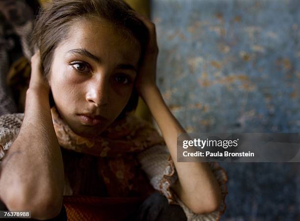 Gulparai looks on at home after smoking heroin with her mother Sabera and brother Zaher August 27, 2007 in Kabul, Afghanistan. Gulparai's mother,...