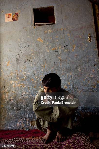 Zaher sits at home after smoking heroin with his mother Sabera and sister Gulparai August 27, 2007 in Kabul, Afghanistan. Zaher's mother, Sabera, a...