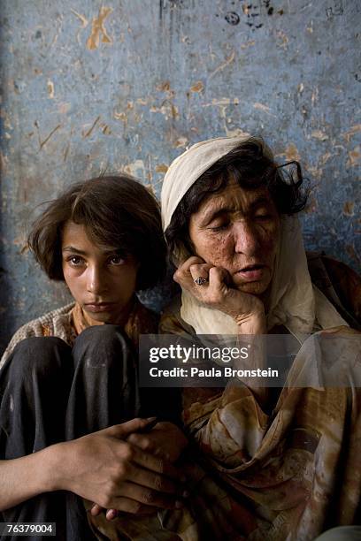 Sabera sits along side her daughter Gulparai August 27, 2007 in Kabul, Afghanistan. Sabera, a widow, has been smoking for four years since she lost...