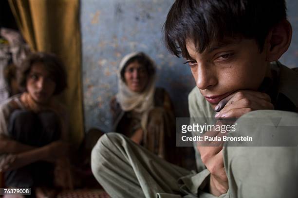 Zaher sits 'stoned' after smoking heroin along side his mother Sabera and sister Gulparai August 27, 2007 in Kabul, Afghanistan. Zaher's mother,...