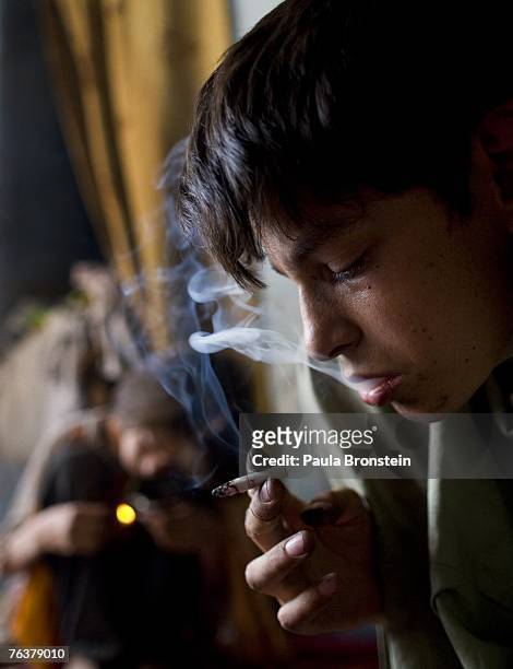 Zaher smokes heroin August 27, 2007 in Kabul, Afghanistan. Zaher's mother, Sabera, a widow, has been smoking for four years since she lost her...