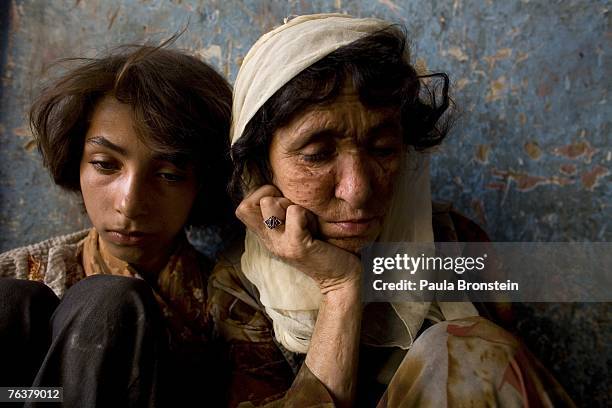 Sabera sits along side her daughter Gulparai August 27, 2007 in Kabul, Afghanistan. Sabera, a widow, has been smoking for four years since she lost...