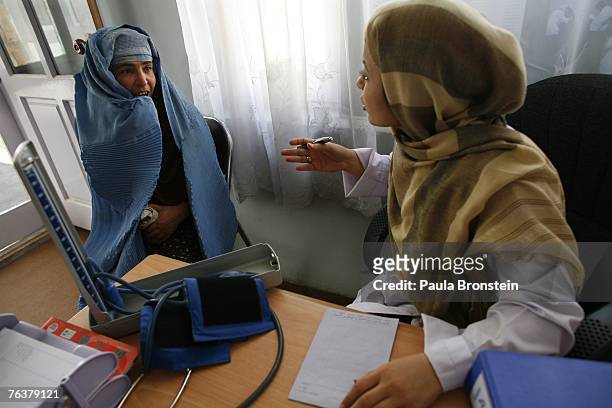 Nurse counsels a former drug addict at the women's drop-in center at the New Life Center August 28, 2007 in Kabul, Afghanistan. Farmers in the...