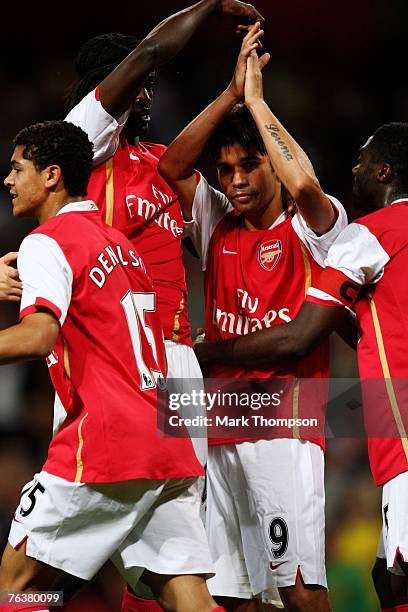 Eduardo of Arsenal is congratulated by team mate Emmanuel Adebayor after he scores a goal during the UEFA Champions League qualifying second leg...