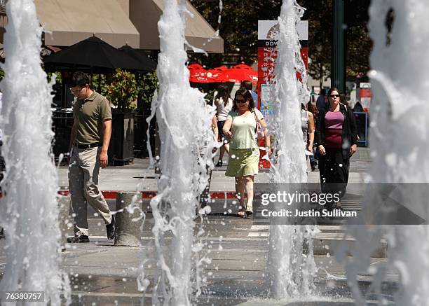 Pedestrians walk by a fountain outside of the Fairmont Hotel August 29, 2007 in downtown San Jose, California. The U.S. Census Bureau released its...