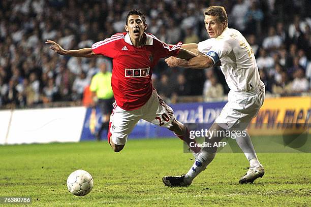 Benfica's Di Maria is tackled by FC Copenhagen's Michael Gravgaard during their UEFA Champions League third round second leg qualifying football...