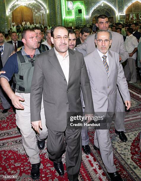 This handout image from the Iraqi Prime Minister office shows Iraq's Prime Minister Nuri al-Maliki and Iraqi national security advisor Muwafak...