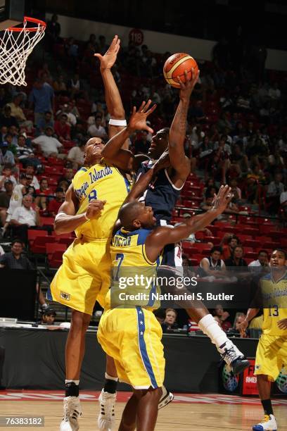Amare Stoudemire of the USA Men's Senior National Team goes up for a shot against Ja Ja Richards and Cuthbert Victor of the Virgin Islands during the...