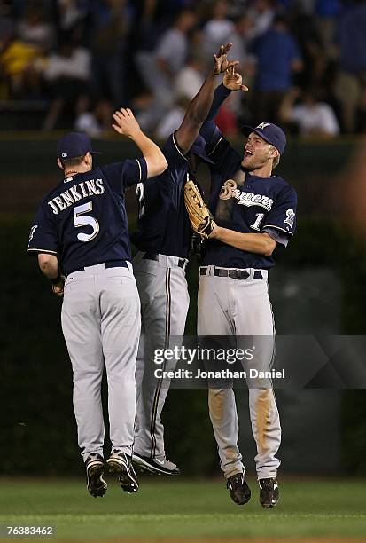 Geoff Jenkins, Bill Hall and Corey Hart of the Milwaukee Brewers celebrate a win over the Chicago Cubs on August 29, 2007 at Wrigley Field in...