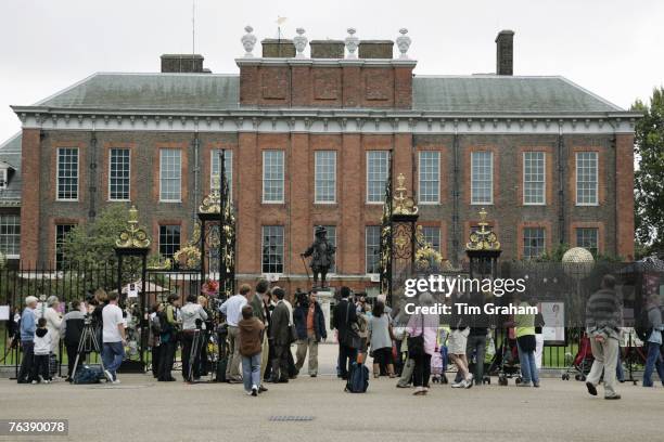 Photographers and television crews join members of the public viewing tributes left in memory of the late Diana, Princess of Wales at the gates of...