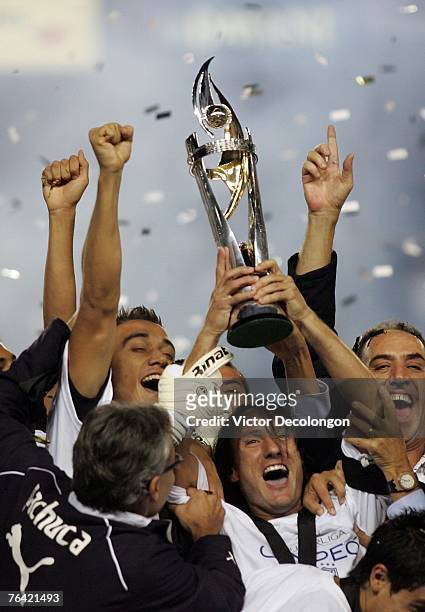 Gabriel Caballero of Pachuca hoists the SuperLiga trophy after they defeated the Los Angeles Galaxy 4-3 on penalty kicks after the game ended in a...