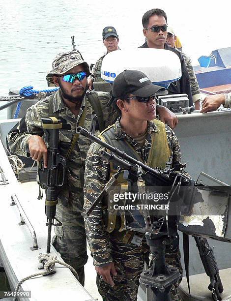 Elite Philippine Navy commandos belonging to the Naval Special Operations Group, secure the waters of Bongao while US Ambassador Kristie Kenney...