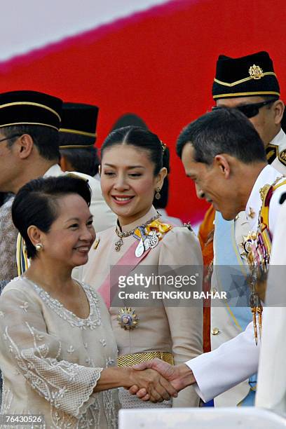 Philippine President Gloria Arroyo shakes hands with Thailand's Crown Price Maha Vajiralongkorn as his royal consort Princess Srirasmi looks on as...