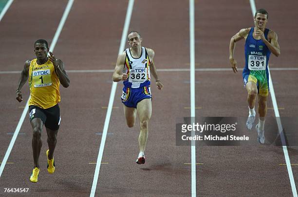 Maurice Smith of Jamaica, Francois Gourmet of Belgium and Carlos Eduardo Chinin of Brazil compete in the 400m Round of the Men's Decathlon on day...