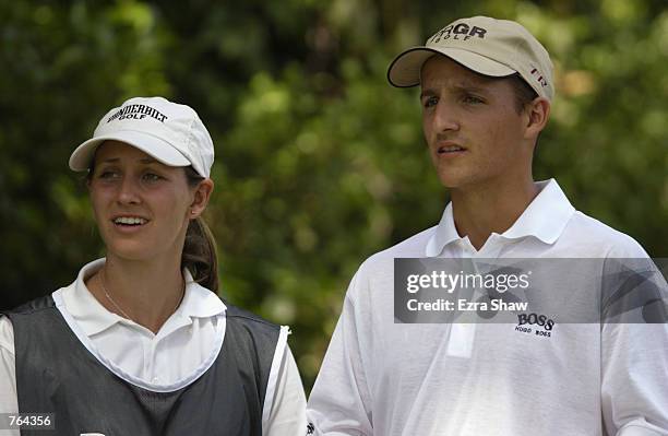 Joni Gossett and her brother David Gossett look over a shot on June 8, 2002 during the third round of the Buick Classic at Westchester CC in...