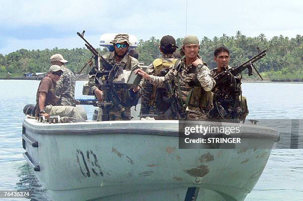 Elite Philippine Navy commandos belonging to the Naval Special Operations Group, secure the waters of Bongao while US Ambassador Kristie Kenney...