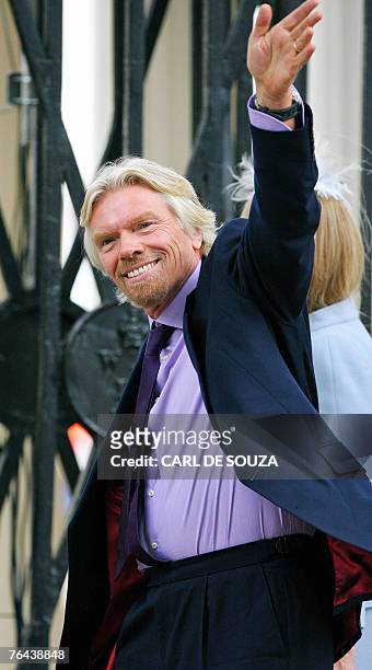 Chairman of Virgin Airlines, British Sir Richard Branson, Sir Richard Branson, waves to the crowd as he arrives with his wife Joan at Wellington...