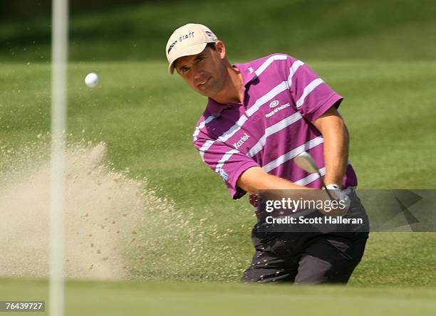 Padraig Harrington of Ireland hits a bunker shot on the 14th hole during the first round of the Deutsche Bank Championship, the second event of the...