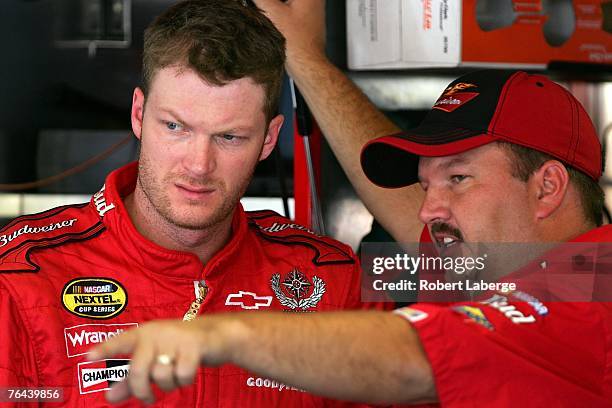 Dale Earnhardt Jr. , driver of the Budweiser Chevrolet, talks with his crew chief, Tony Eury Jr. In the garage prior to practice for the NASCAR...