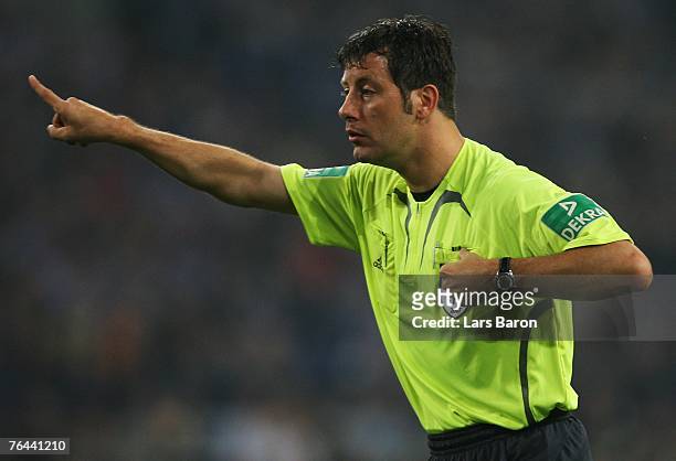 Referee Wolfgang Strak gestures during the Bundesliga match between FC Schalke 04 and Bayer Leverkusen at the Veltins Arena on August 31, 2007 in...