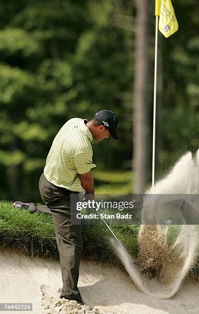 Tiger Woods hits his ball out of the bunker at the fourth hole during the first round of the Deutsche Bank Championship at TPC Boston on August 31,...
