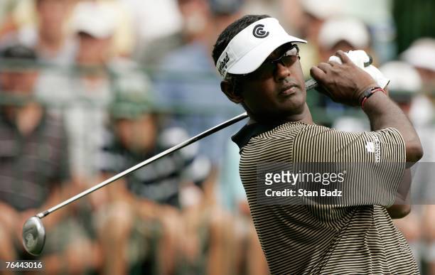 Vijay Singh listens to MP3 music during a practice swing during the first round of the Deutsche Bank Championship at TPC Boston on August 31, 2007 in...