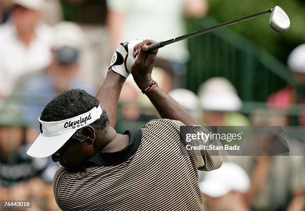 Vijay Singh listens to MP3 music during a practice swing during the first round of the Deutsche Bank Championship at TPC Boston on August 31, 2007 in...