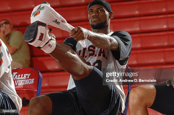 LeBron James of the USA Basketball Men's Senior National Team stretches during training camp on August 18, 2007 at Valley High School in Las Vegas,...
