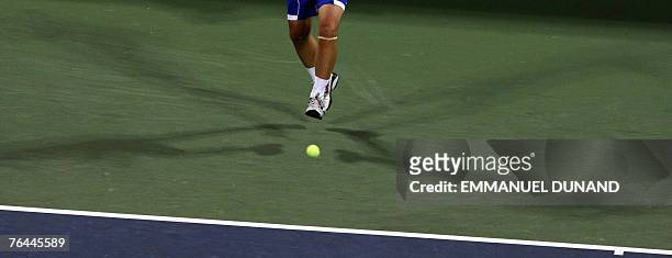 Ball bounce between the shadows of Argentinian tennis player Agustin Calleri during his match against sixteen-seed Australian player Lleyton Hewitt...