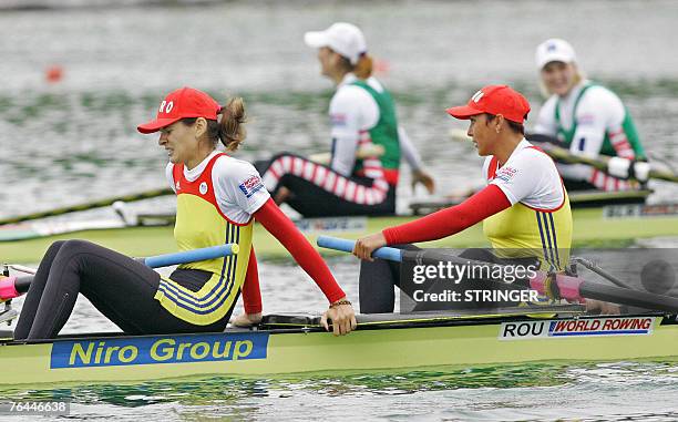 Romania's Georgeta Damian-Andrunache and Viorica Susanu look on after placing third of the women's pairs final race of the Rowing World...