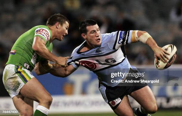 Paul Gallen of the Cronulla Sharks passes the ball during the round 25 NRL match between the Canberra Raiders and the Cronulla-Sutherland Sharks at...