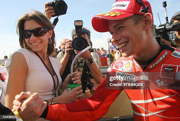 Australian rider Casey Stoner with his wife Adriana celebrates after gaining pole position at MotoGP San Marino Grand Prix in Misano Adriatico, 01...