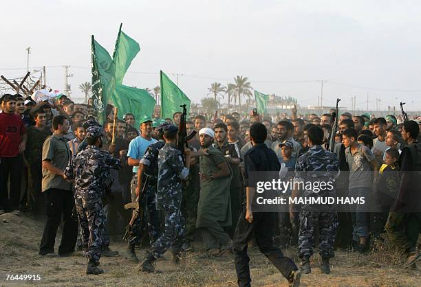 Members of the Hamas executive force stop supporters from crossing the Rafah border in southern Gaza Strip during a protest urging the Egyptian...