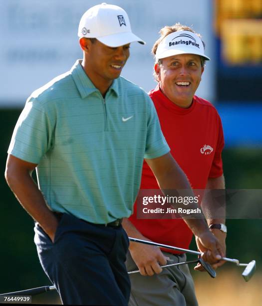 Tiger Woods and Phil Mickelson walk to the 2nd green during the second round of Deutsche Bank Championship, the second event of the new PGA TOUR...