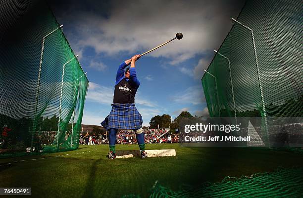 Competitor throws a hammer during the Braemar Highland Games Gathering at the Princess Royal and Duke of Fife Memorial Park on September 1, 2007 in...