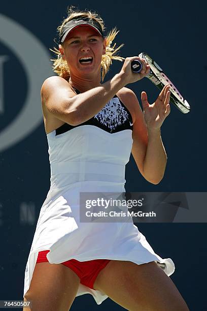 Maria Sharapova returns a shot against Agnieszka Radwanska of Poland during day six of the 2007 U.S. Open at the Billie Jean King National Tennis...