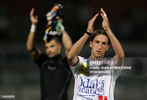 Nancy's defender Frederic Biancalani and goalkeeper Gennaro Bracigliano wave to the crowd at the end of the French L1 football match Nancy vs...