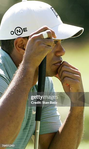 Tiger Woods studies his putt at the first green during the second round of the Deutsche Bank Championship, the second event of the new PGA TOUR...