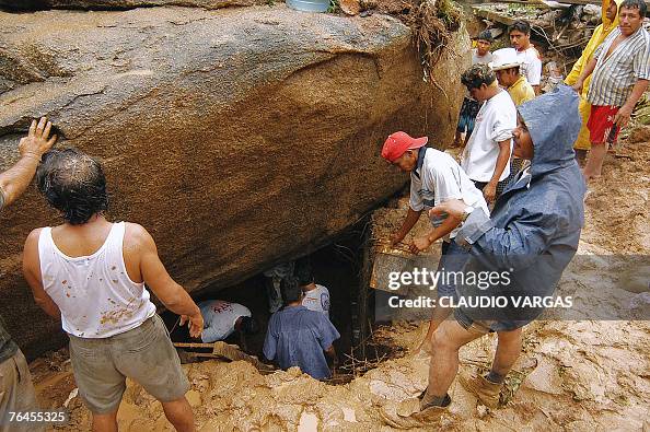 Man Digging Rocks People work digging under a huge rock which fell down on top of a ...