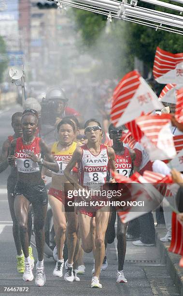 Marathon women athletes Kenyan Rita Jeptoo Sitienei, China's Chunxiu Zhou, Japanese Reiko Tosa and Kenyan Catherine Ndereba run through Osaka streets...