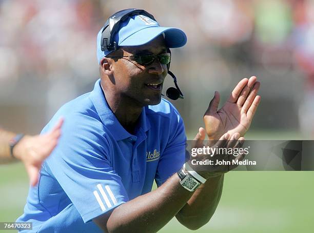 Head coach Karl Dorrell of the UCLA Bruins encourages his team during the UCLA 45-17 defeat of the Stanford Cardinal at Stanford Stadium September 1,...