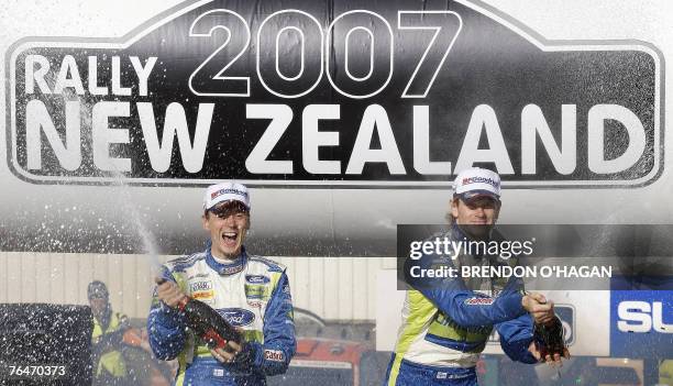 Marcus Gronholm and co-driver Timo Rautiainen of Finland stand on their Ford Focus Rs as they celebrate victory in the Rally of New Zealand at the...