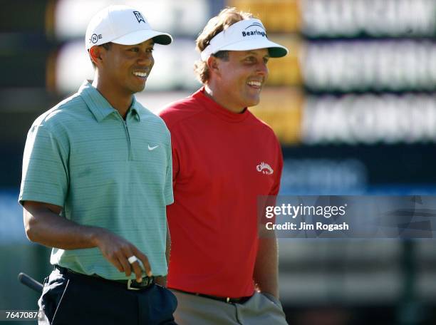 Tiger Woods and Phil Mickelson walk to the second green during the second round of Deutsche Bank Championship, the second event of the new PGA TOUR...