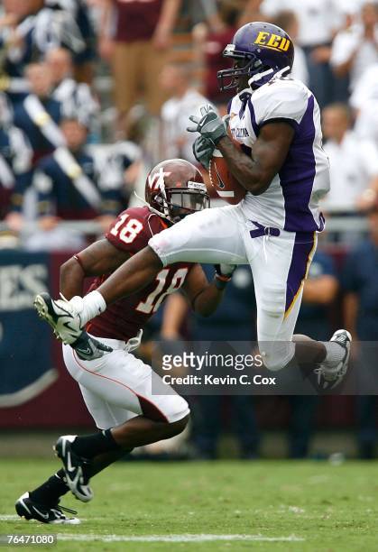 Wide receiver Jamar Bryant of the East Carolina Pirates pulls in a reception against cornerback Brandon Flowers of the Virginia Tech Hokies during...
