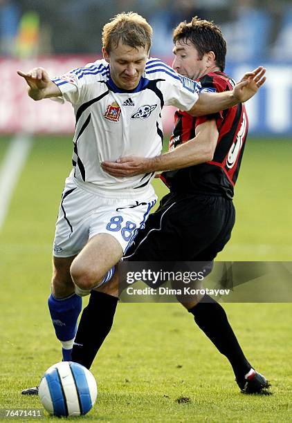 Aleksey Ivanov of FC Saturn Moscow Oblast competes for the ball with Yuri Drozdov of FC Khimki during the Russian Football League Russian Premier...