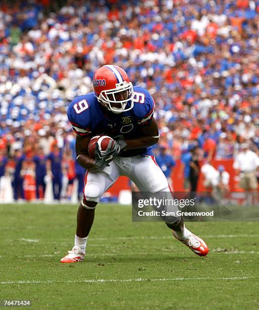 Louis Murphy#9 of the Florida Gators catches a pass against the Western Kentucky Hilltoppers on September 1, 2007 at Ben Hill Griffin Stadium in...