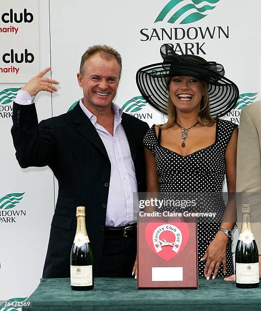 Comedian Bobby Davro and actress Malandra Burrows present the trophy for the first race of the day at the 49th Variety Club Race Day at Sandown race...